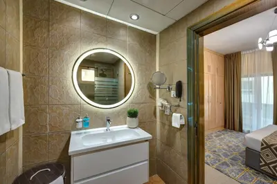a bathroom with a sink and a mirror at Radiance Premium Suites in Dubai