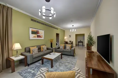 a living room with a couch and a tv at Radiance Premium Suites in Dubai