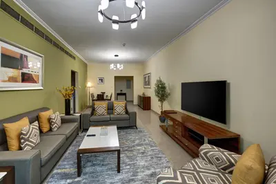 a living room with couches and a flat screen tv at Radiance Premium Suites in Dubai