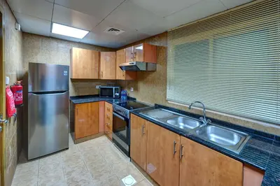 a kitchen with a stainless steel refrigerator and a sink at Radiance Premium Suites in Dubai