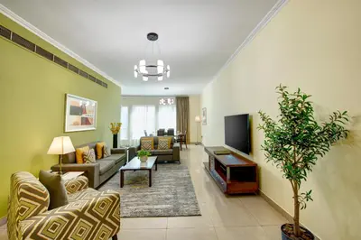 a living room with a couch and a tv at Radiance Premium Suites in Dubai