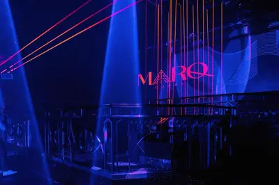 a dark room with a neon sign and chairs at Dubai Marine Beach Resort & Spa in Dubai