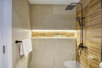 a bathroom with a shower with a sink and a toilet at The Smart Concierge - Discovery Gardens street 4 in Dubai