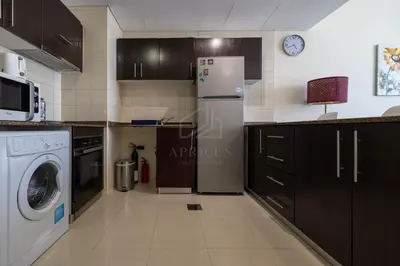 a kitchen with a refrigerator and a washer and dryer at Awesome Marina Canal View 1BD Bay Central Marina in Dubai