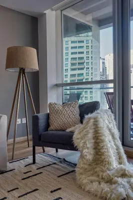 a living room with a couch and a large window at The Smart Concierge - Damac Waves in Dubai