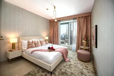 a bedroom with a large bed and a large window at Durrani Homes - Designer 2BR Apt with stunning Burj khalifa and Fountain View in Dubai