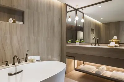 a bathroom with a tub and two sinks at Jumeirah Beach Hotel Dubai in Dubai