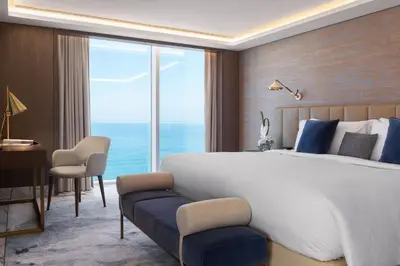 a bedroom with a large bed and a large window at Jumeirah Beach Hotel Dubai in Dubai