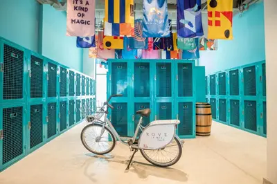 a bike parked in a room with lockers at Rove La Mer Beach, Jumeirah in Dubai