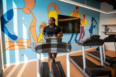 a woman riding on a treadmill in a gym at Rove La Mer Beach, Jumeirah in Dubai