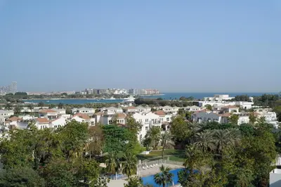 an aerial view of a city with houses and trees at Holiday Inn Express Dubai Internet City by IHG in Dubai