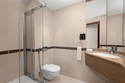 a bathroom with a toilet and a sink and a shower at Holiday Inn Express Dubai Internet City by IHG in Dubai
