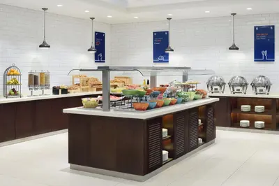 a buffet counter with food on it in a store at Holiday Inn Express Dubai Internet City by IHG in Dubai