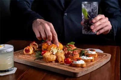 a person is preparing food on a cutting board at Radisson Blu Hotel, Dubai Media City in Dubai