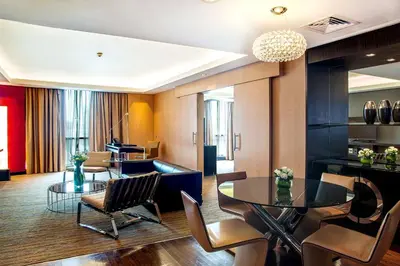 a living room with a table and chairs at Radisson Blu Hotel, Dubai Media City in Dubai