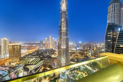 a view of a city skyline at night at FIRST CLASS 3BR with full BURJ KHALIFA and FOUNTAIN VIEW in Dubai