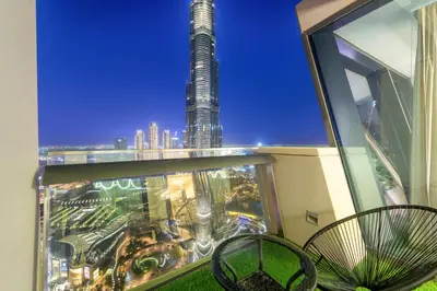 a view of a city from the balcony of a building at FIRST CLASS 3BR with full BURJ KHALIFA and FOUNTAIN VIEW in Dubai