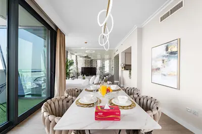 a dining room with a white table and chairs at FIRST CLASS 3BR with full BURJ KHALIFA and FOUNTAIN VIEW in Dubai