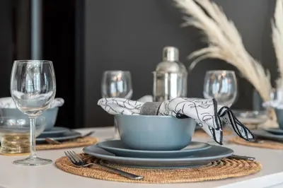 a table with a table set with glasses and a blue bowl at The Smart Concierge - Bay Central in Dubai