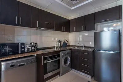 a kitchen with a stainless steel refrigerator and a dishwasher at The Smart Concierge - Bay Central in Dubai