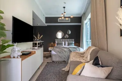a living room with a bed and a couch at The Smart Concierge - Bay Central in Dubai