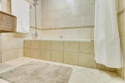a bathroom with a bath tub and a rug at Sea View Studio 10min from beach Royal Oceanic in Dubai