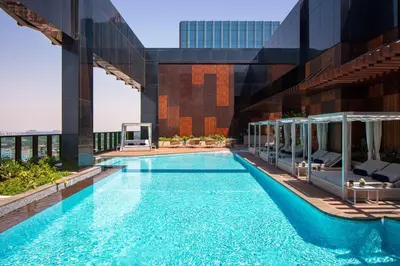 a swimming pool on the roof of a building at DoubleTree by Hilton Dubai M Square Hotel & Residences in Dubai