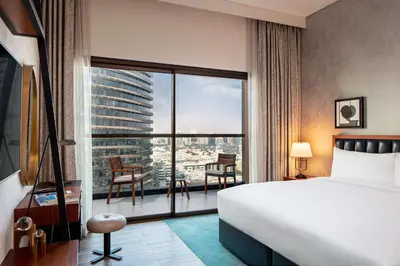 a hotel room with a bed and a large window at DoubleTree by Hilton Dubai M Square Hotel & Residences in Dubai