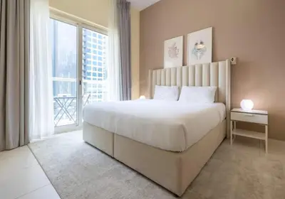 a bedroom with a large bed and a large window at Splendid Studio in Marina View Towers in Dubai