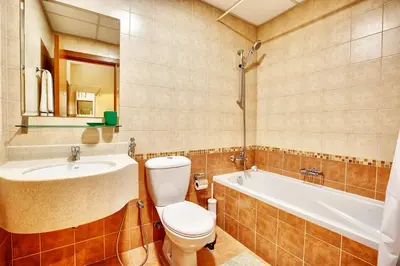 a bathroom with a toilet and a sink and a tub at Splendid Studio in Marina View Towers in Dubai