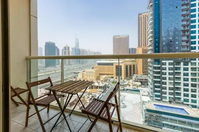 two chairs and a table on a balcony with a view at Splendid Studio in Marina View Towers in Dubai