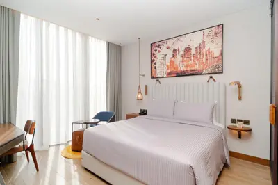 a bedroom with a white bed and a desk at Barcelo Business Bay Dubai in Dubai