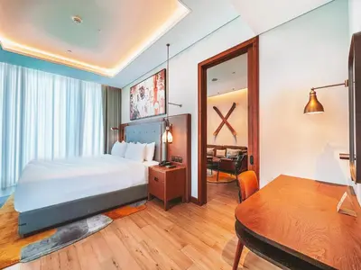 a hotel room with a bed and a table at Barcelo Business Bay Dubai in Dubai