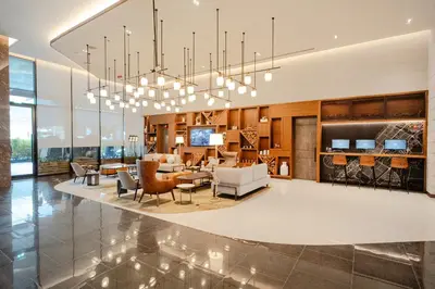 a large living room with a chandelier at Barcelo Business Bay Dubai in Dubai