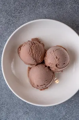a white plate with chocolate ice cream on a table at Element Al Jaddaf, Dubai in Dubai