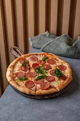 a pepperoni pizza sitting on top of a table at Element Al Jaddaf, Dubai in Dubai