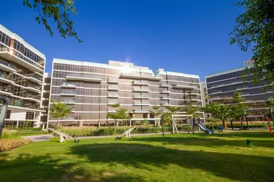 a large building with a playground in a park at Bespoke Holiday Homes - Palm Jumeirah- 2 Bedroom Sea View with Pool & Beach Access, The 8 in Dubai