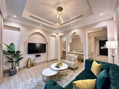 a living room with a couch and a table at Durrani Homes - Heaven On Earth- Burj Khalifa Fireworks in Dubai
