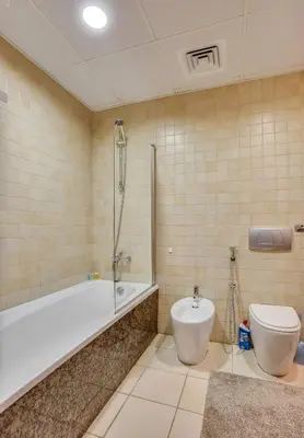 a bathroom with a tub and a toilet at Huge Sea View Studio in Murjan JBR in Dubai