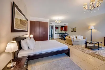 a room with a bed and a living room at Huge Sea View Studio in Murjan JBR in Dubai