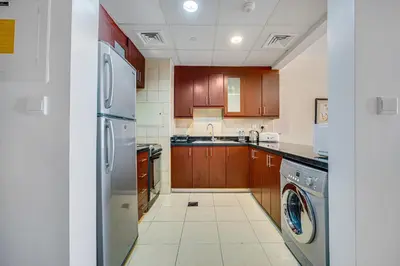 a kitchen with a refrigerator and a dishwasher at Huge Sea View Studio in Murjan JBR in Dubai