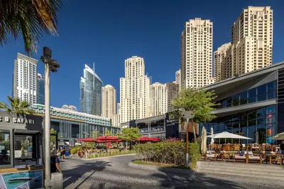 a city with tall buildings and tables and umbrellas at Huge Sea View Studio in Murjan JBR in Dubai