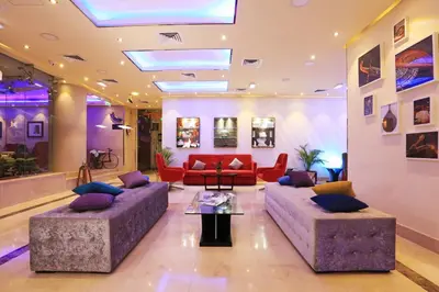 a living room with two couches and a table at MENA ApartHotel Albarsha At The Mall in Dubai