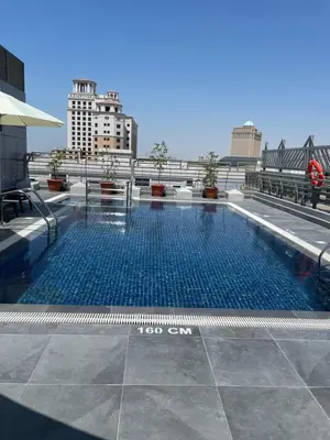 a swimming pool on the roof of a building at MENA ApartHotel Albarsha At The Mall in Dubai
