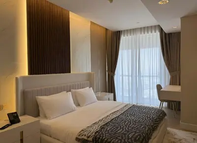 a bedroom with a bed and a large window at Fashion Avenue Dubai Mall-Burj Khalifa by The SHH in Dubai