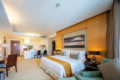 a hotel room with a large bed and a kitchen at Fashion Avenue Dubai Mall-Burj Khalifa by The SHH in Dubai