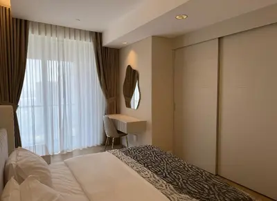 a bedroom with a bed and a desk and a window at Fashion Avenue Dubai Mall-Burj Khalifa by The SHH in Dubai