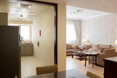 a living room with a couch and a table at Grand Millennium Dubai in Dubai