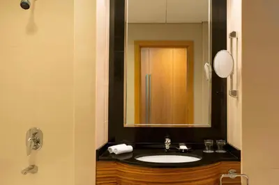 a bathroom with a sink and a mirror at Four Points by Sheraton Bur Dubai in Dubai