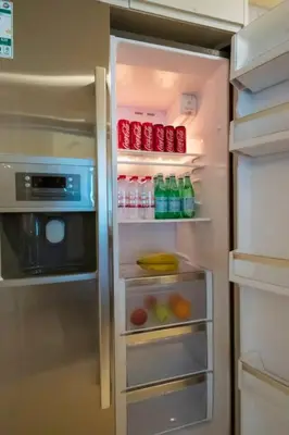 a refrigerator with its door open with drinks in it at Modern 2BR with Balcony Sea Views and Pool, Gym Near Attractions in Dubai